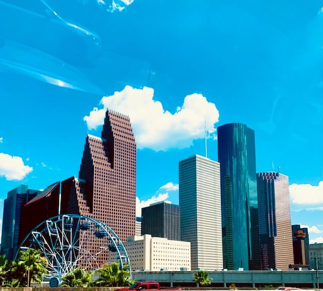 a Houston city skyline with a Ferris wheel in the foreground